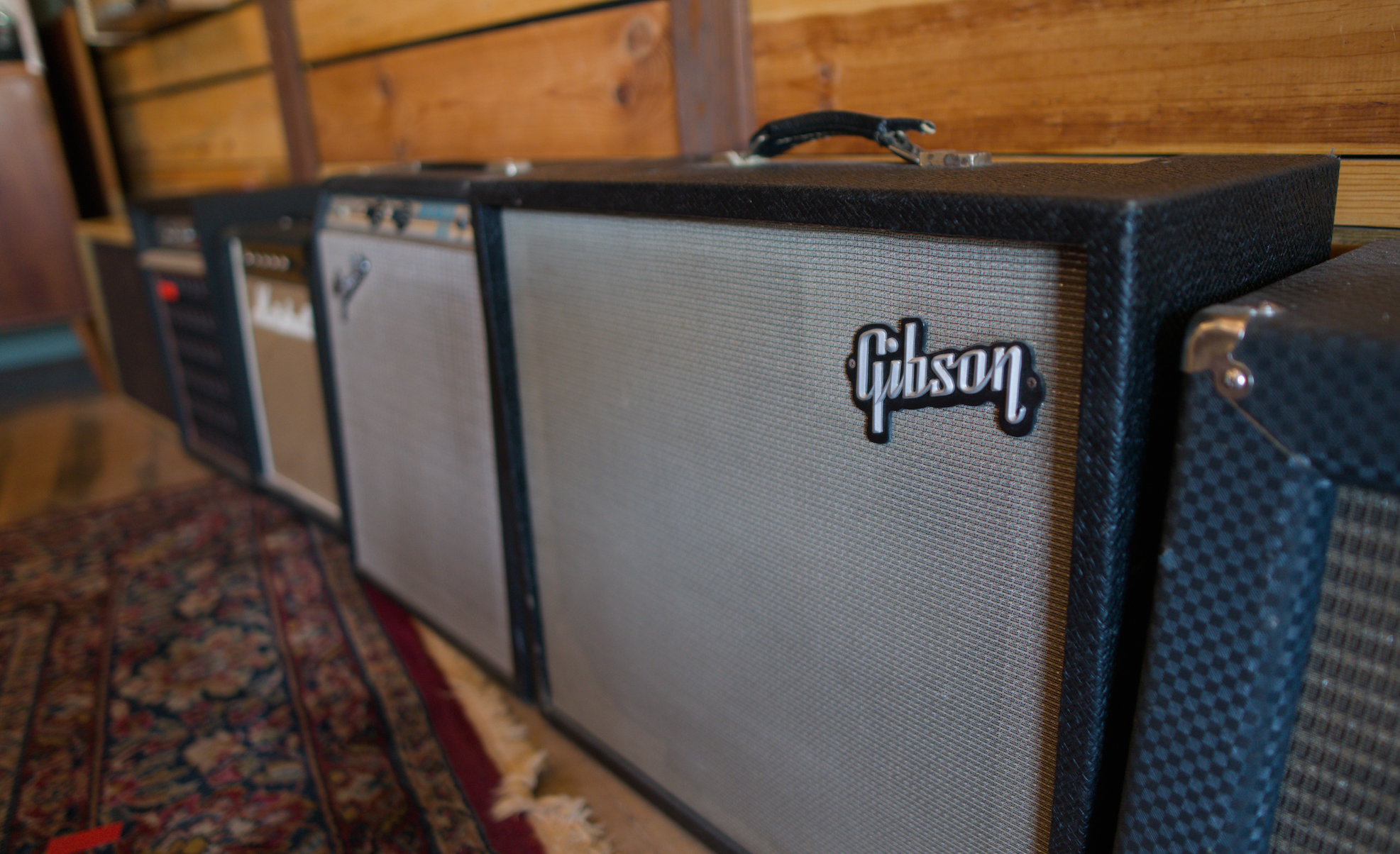 a row of guitar combo amps