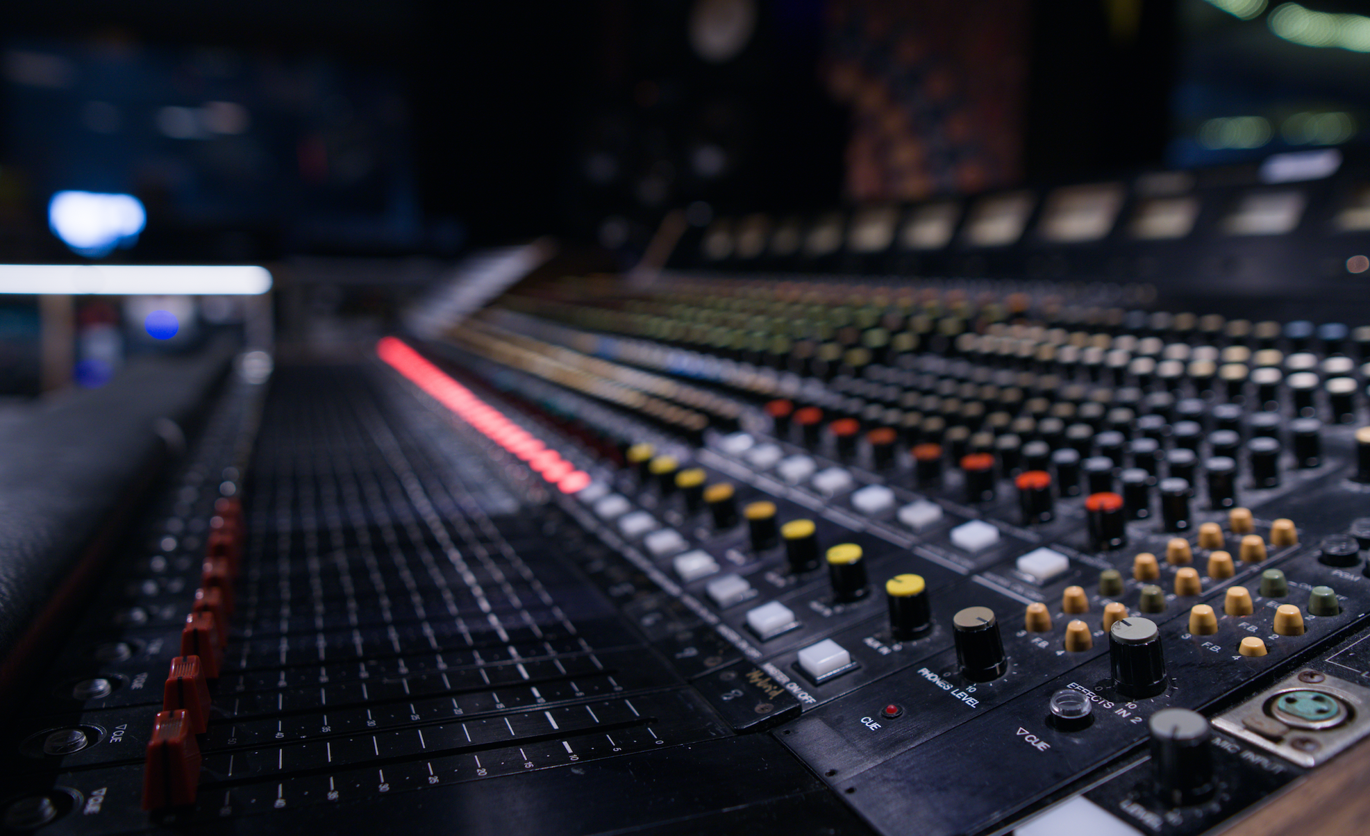 a dramatic shot of a long mixing board