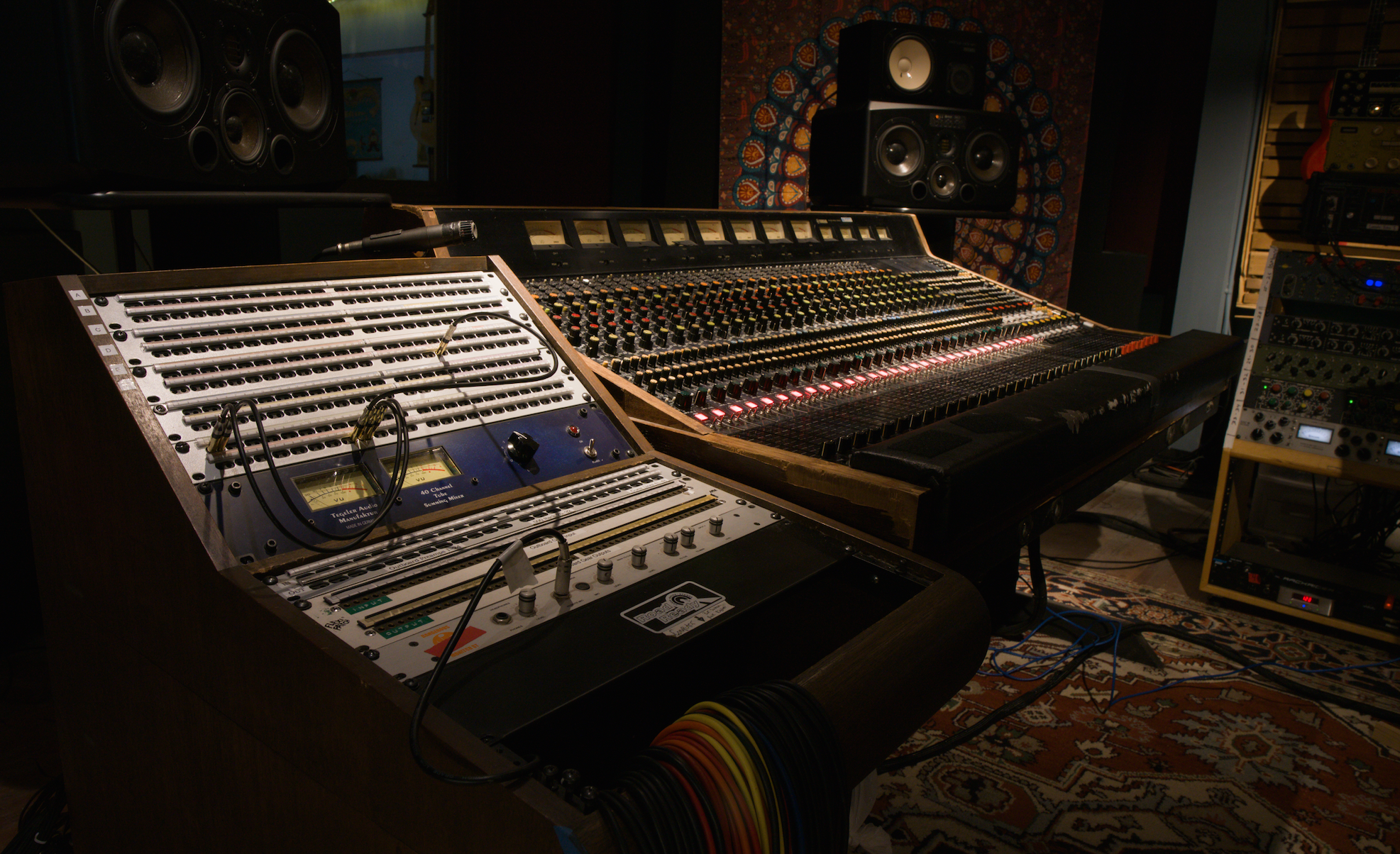 two massive mixing consoles, side by side