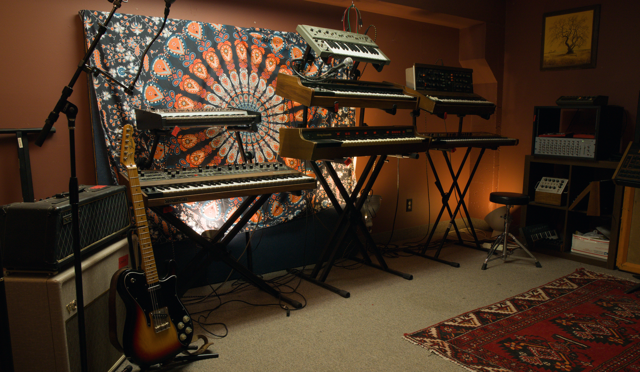 many synthesizers on stands