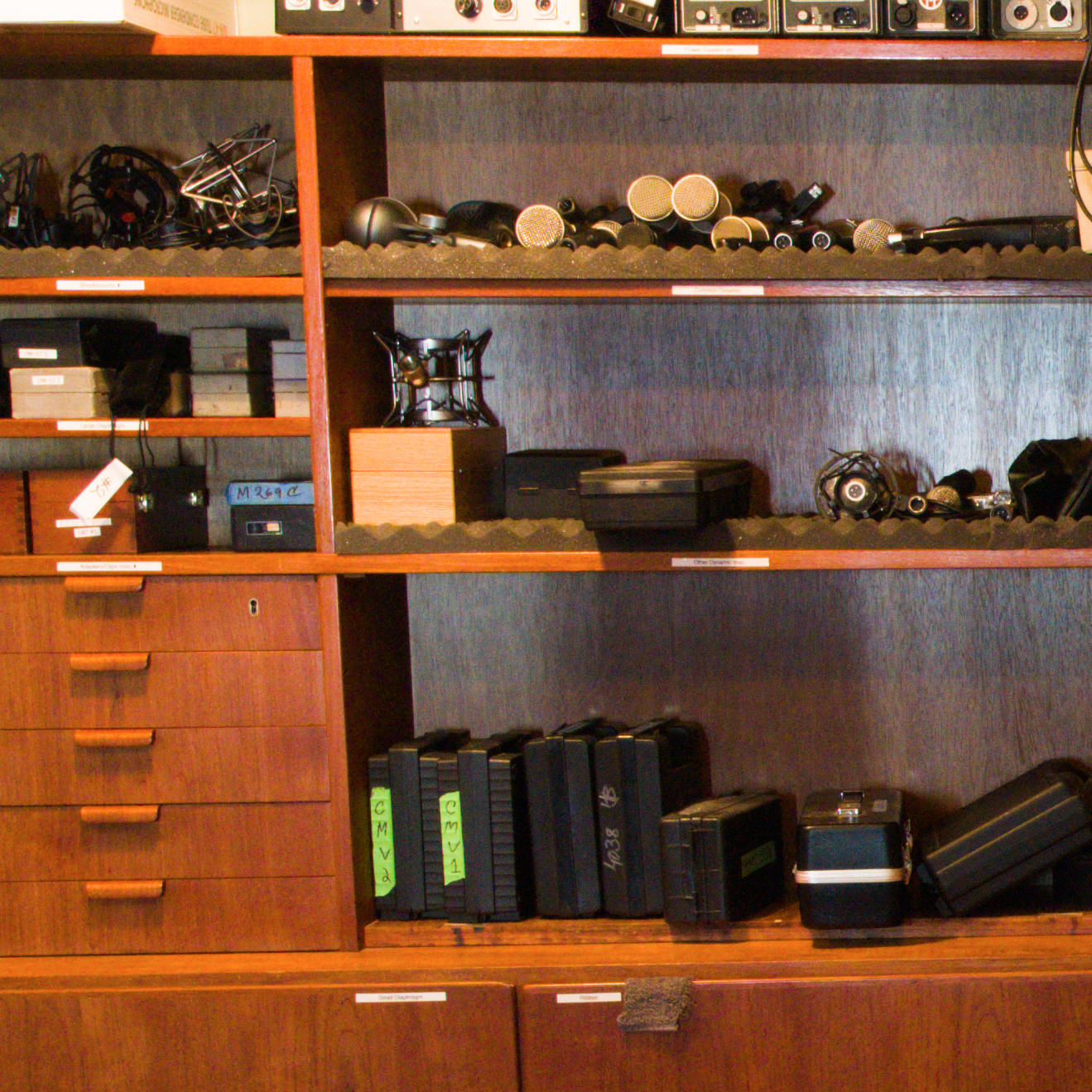 a shelf of microphones
